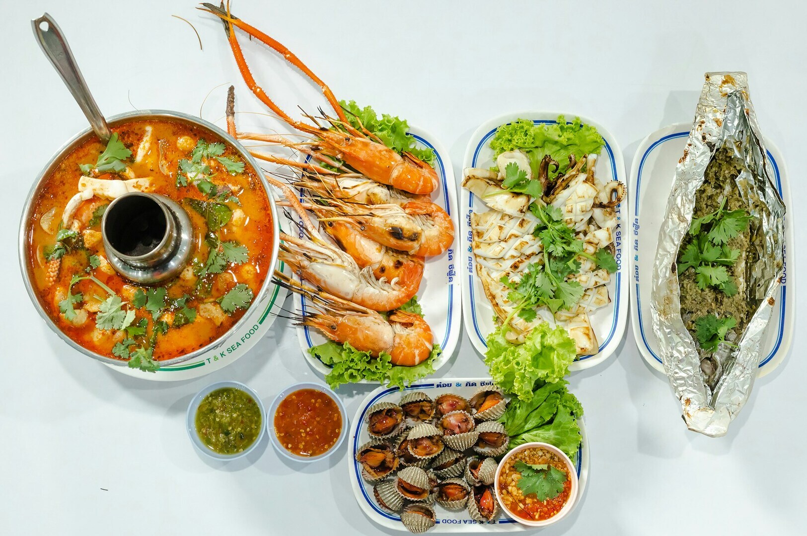 A variety of healthy seafood dishes beautifully arranged on trays, showcasing vibrant colors and fresh ingredients.