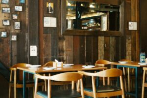 A cozy healthy restaurant featuring wooden walls and chairs, creating a warm and inviting atmosphere for diners.