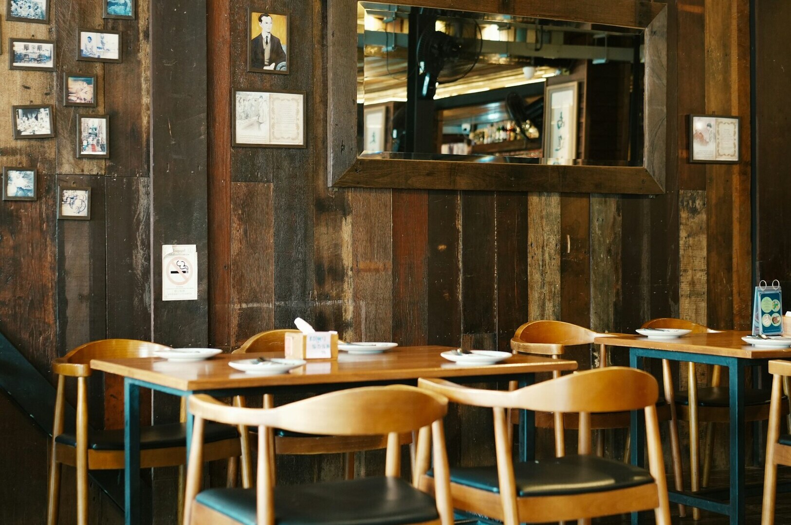 A cozy healthy restaurant featuring wooden walls and chairs, creating a warm and inviting atmosphere for diners.