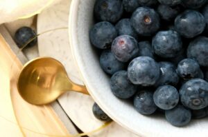 A close-up of blueberries in a bowl, showcasing their deep blue hue and health benefits as an antioxidant food.
