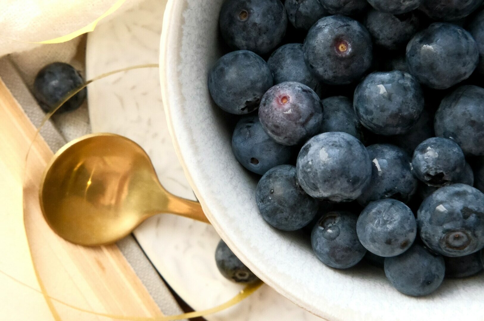 A close-up of blueberries in a bowl, showcasing their deep blue hue and health benefits as an antioxidant food.