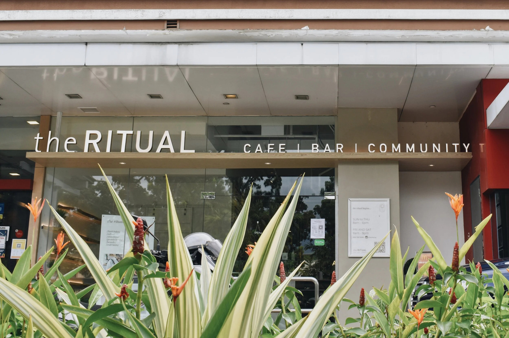 A vibrant scene at The Ritual Cafe and Bar, showcasing a diverse community enjoying drinks and conversation together.