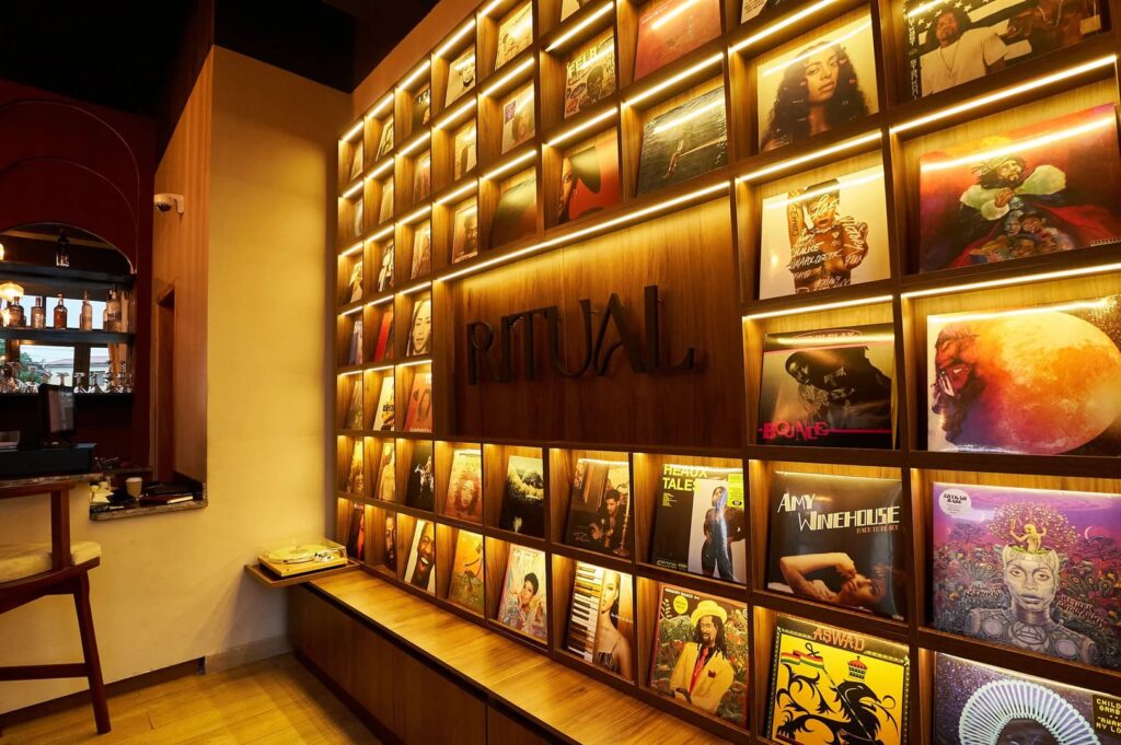 A wall displaying a variety of magazines at The Ritual Cafe and Bar, showcasing diverse topics and styles.