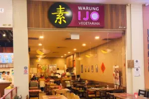 Warung Ijo Vegetarian restaurant storefront and indoor dining area.