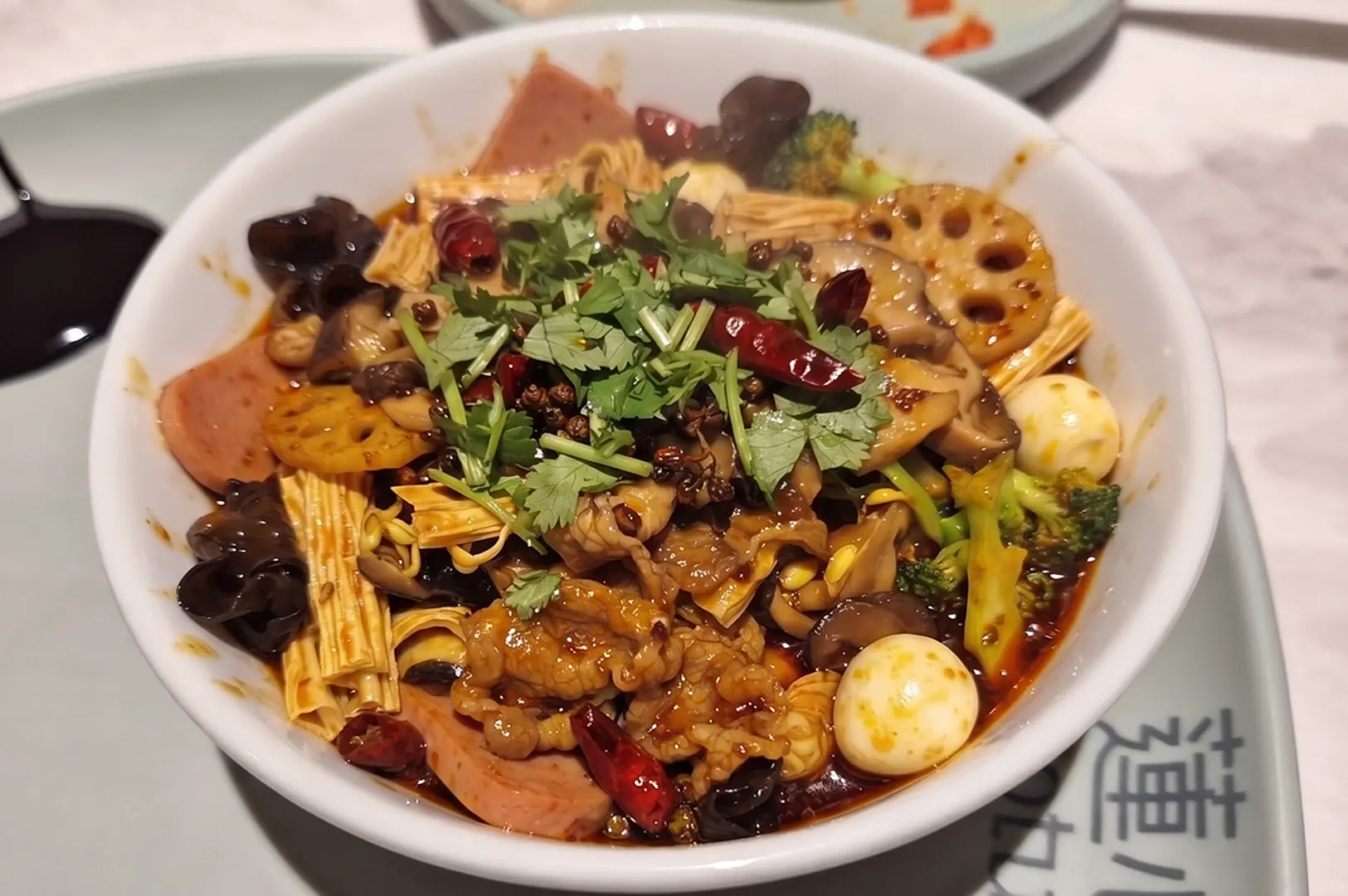 Spicy stir-fry Ma La Xiang Guo dish served in a bowl at Lotus restaurant.