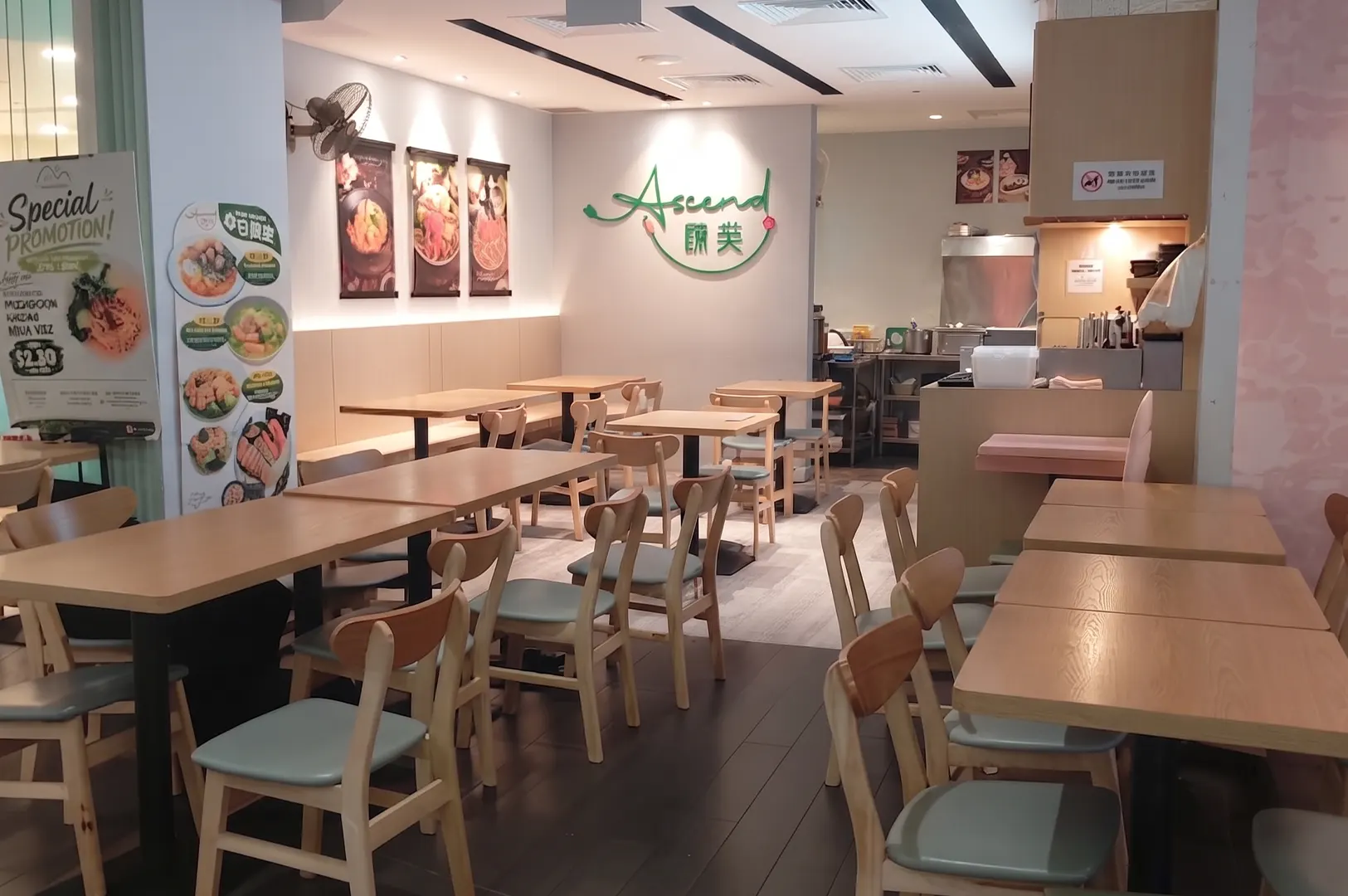 Interior view of Ascend restaurant featuring modern wooden tables and chairs.