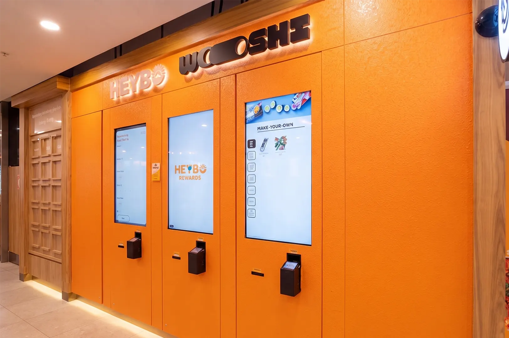 HEYBO and Wooshi automated self-ordering kiosk stations with touchscreens at Dhoby Ghaut Xchange.