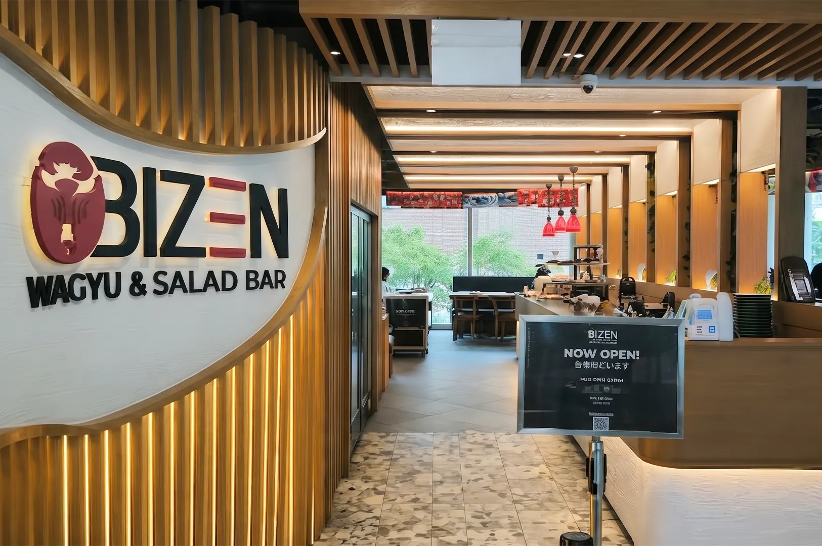 Storefront and entrance of Bizen Wagyu & Salad Bar restaurant with wooden interior design.