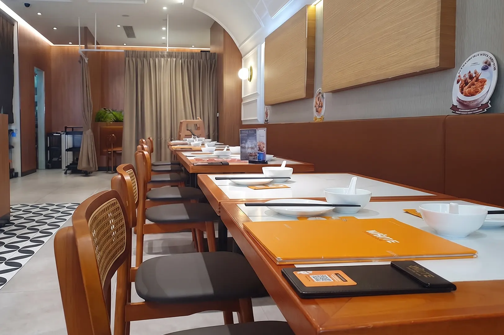 White Restaurant interior at Suntec City featuring wooden dining tables and chairs set for guests.