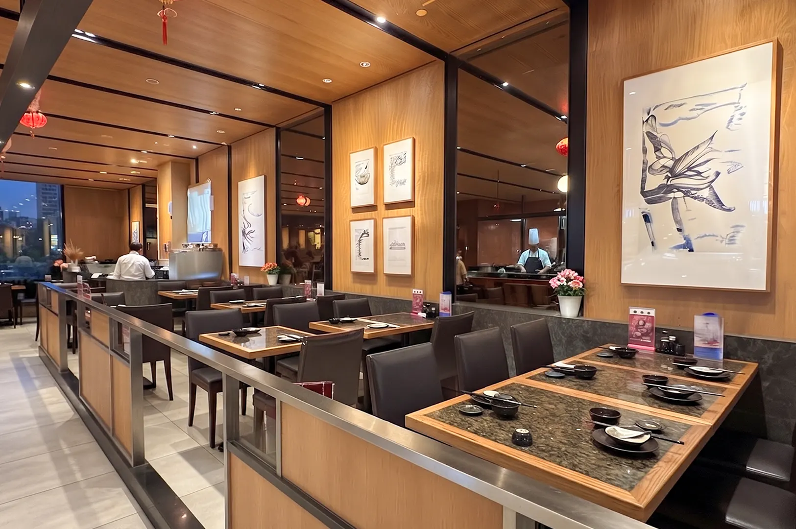 Din Tai Fung restaurant interior at Suntec City featuring modern wooden decor, comfortable dining tables, and a view of the open kitchen.