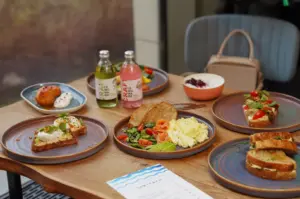 vibrant spread of colorful plant-based dishes served on a restaurant table.