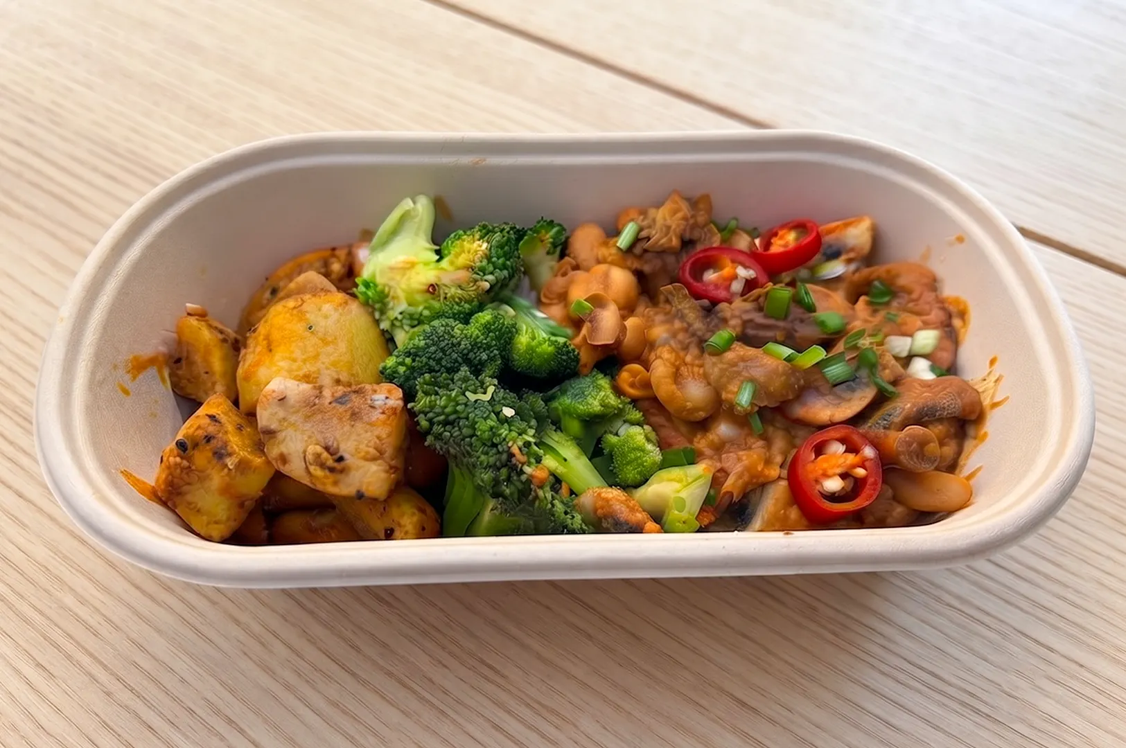 Healthy YoloFoods Asian meal delivery option served in a takeout container.