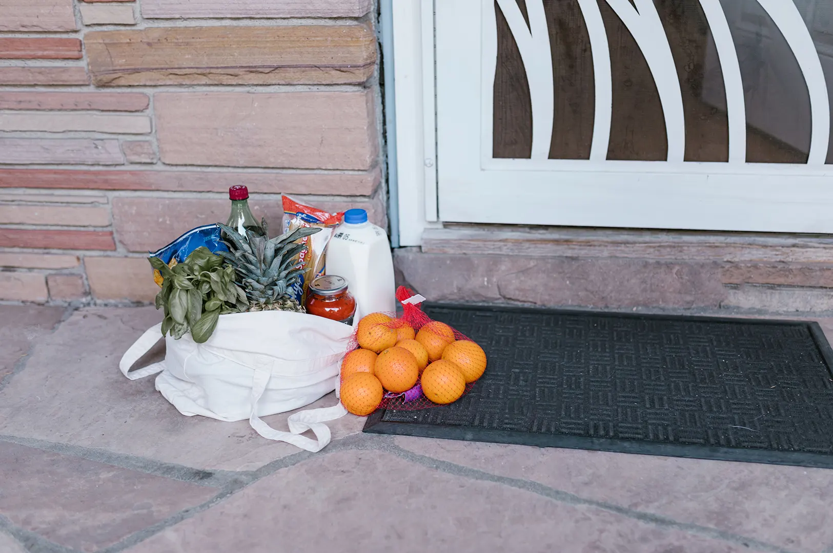 Healthy grocery and fresh food delivery left at a home doorstep.