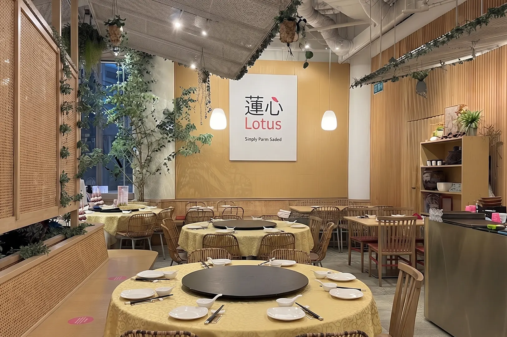 Warm interior dining space of Lotus restaurant with set tables and cozy atmosphere.