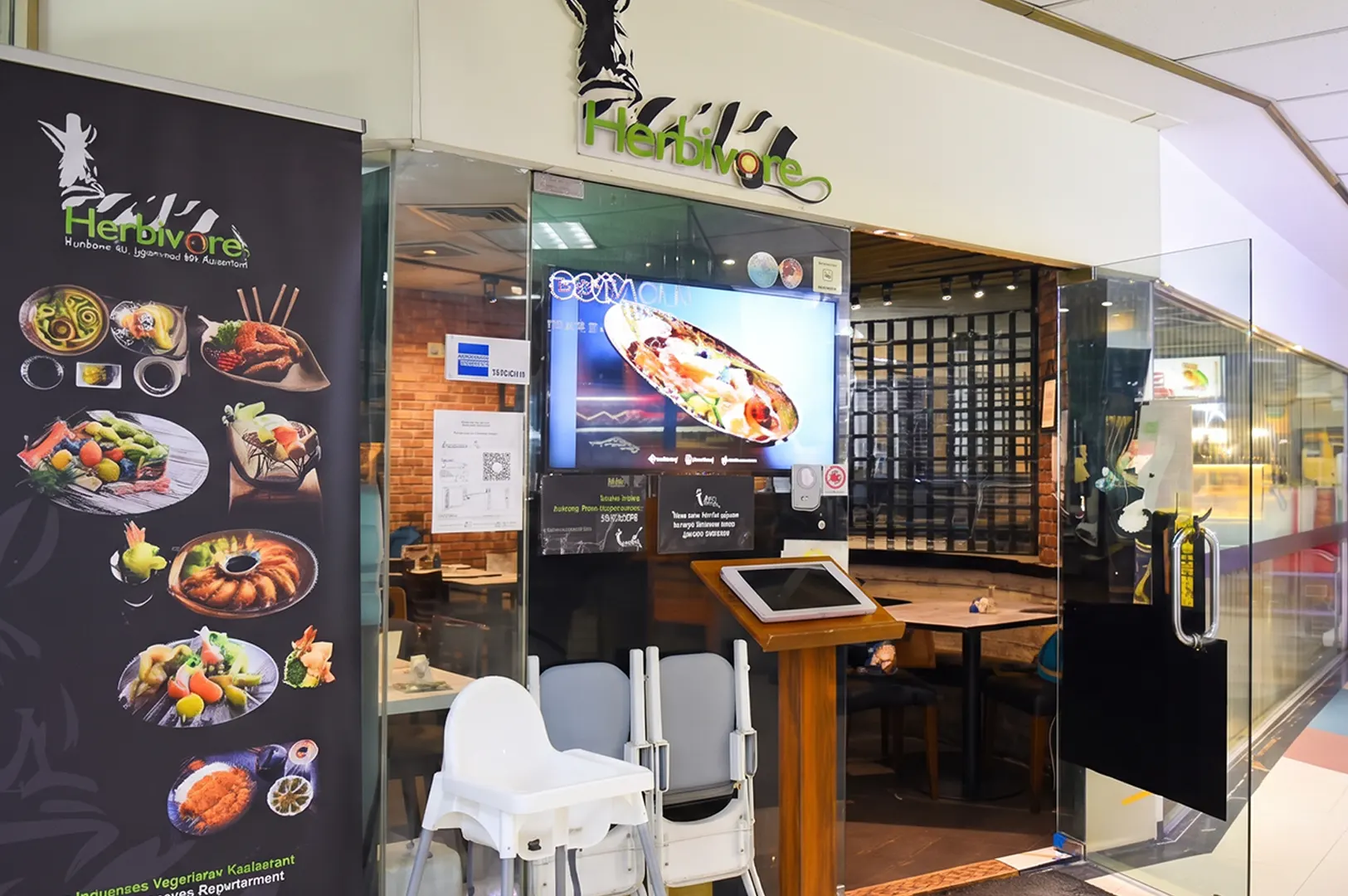 Facade and entrance of Herbivore Japanese vegetarian restaurant in Singapore.