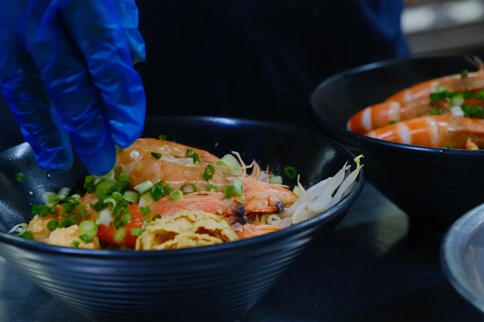 Chef preparing a bowl of healthy shrimp fish soup with fresh vegetables.