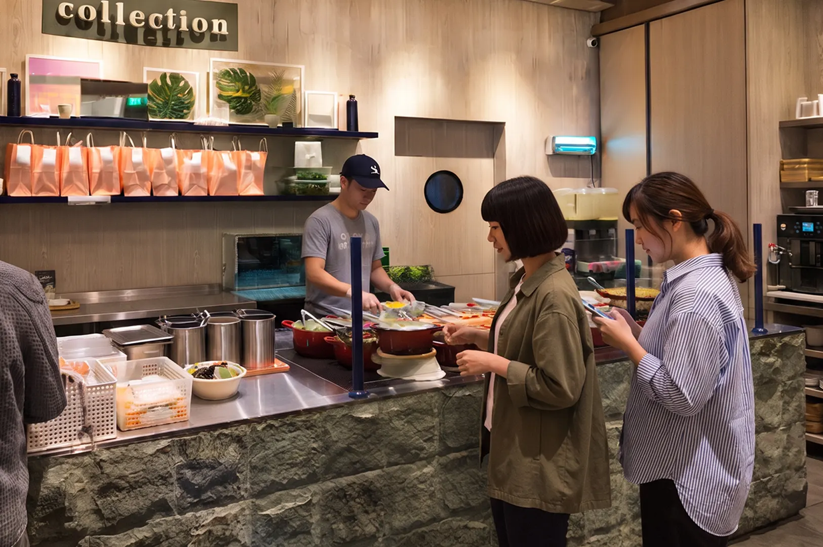 Customers ordering at a custom bowl restaurant counter.