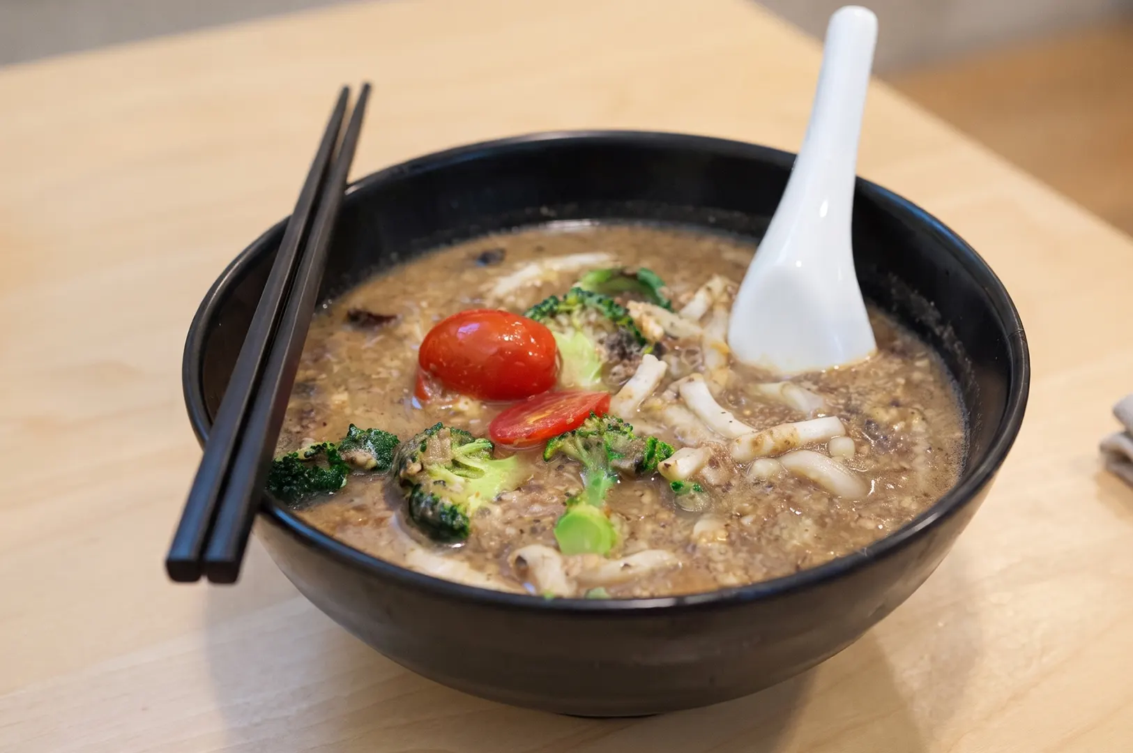 Tracy's Special Mushroom Udon bowl with thick gravy, broccoli, and tomatoes.