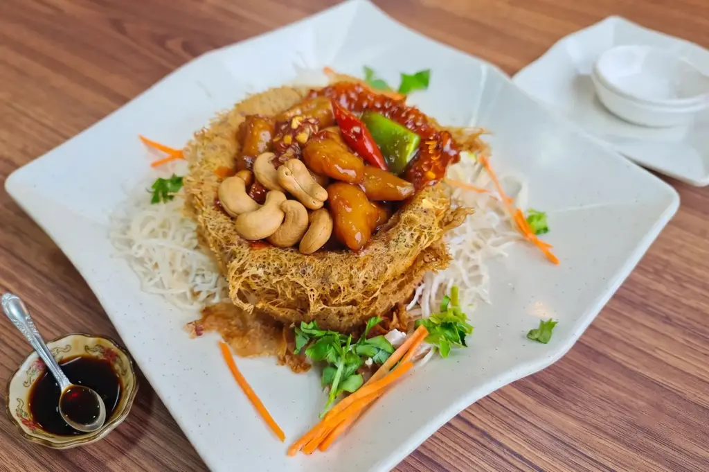 Fragrant Yam Ring dish featuring a crisp fried taro shell filled with savory stir-fried mock meat and toppings.