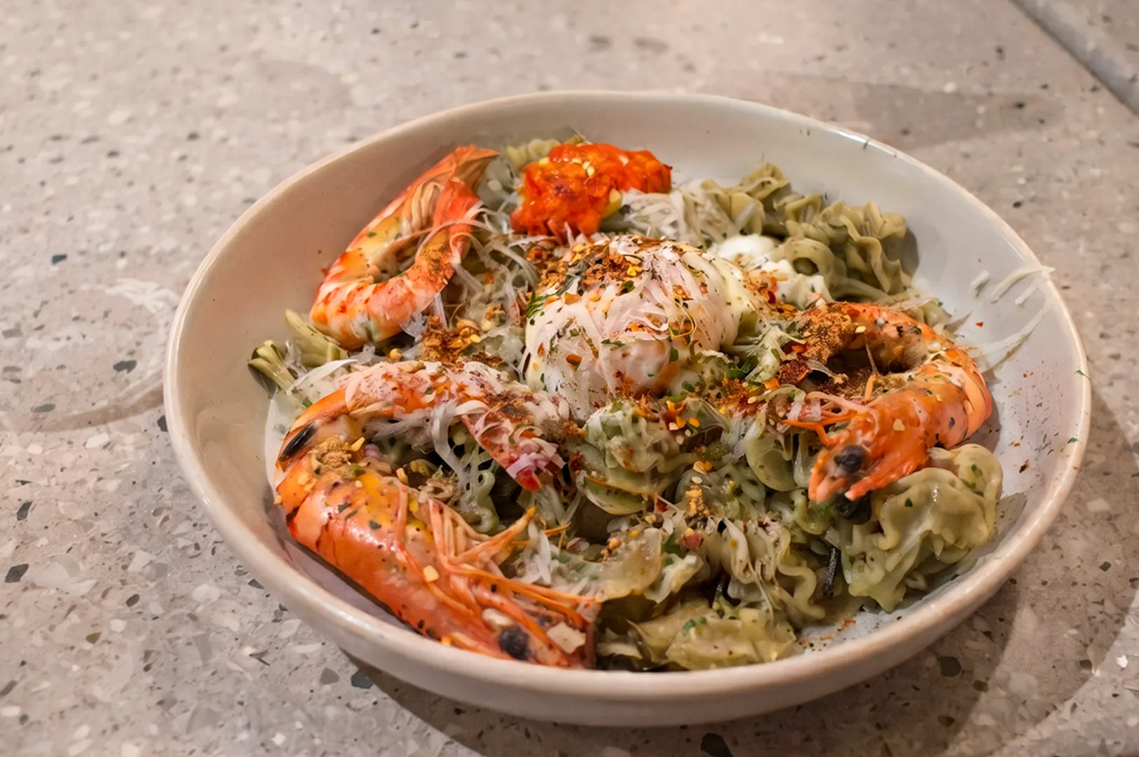 Tipo Singapore Aglio Alright pasta with tiger prawns and sous vide egg.