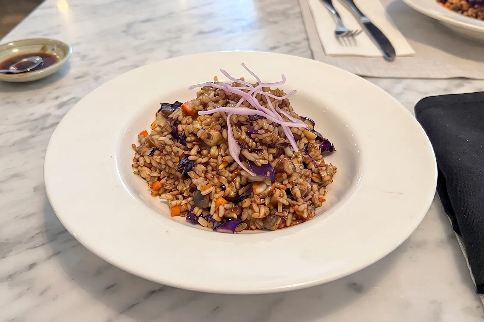 The Fried Brown Rice served in a white bowl at Real Food.